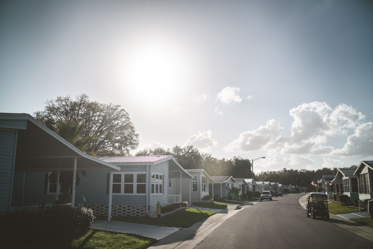 Row of well-kept manufactured homes on a quiet street in a mobile home community like homes for sale near Butler PA
